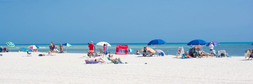 A sunny beach scene with people relaxing